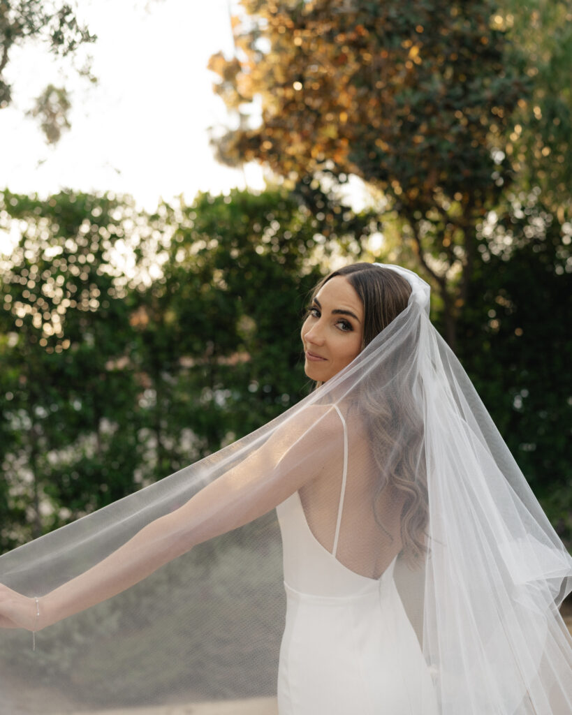 bride in modern minimalist wedding dress and cathedral veil 