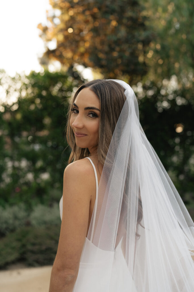 bride in modern minimalist wedding dress and cathedral veil 