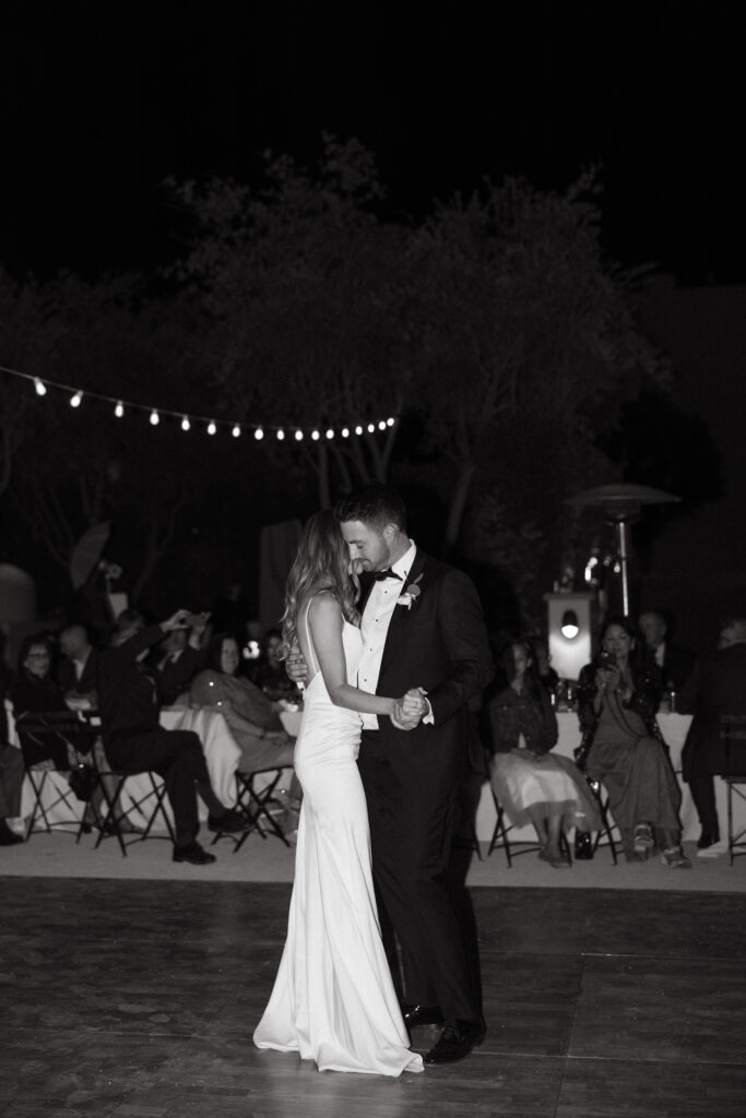 black and white photo of bride and groom first dance during wedding reception 