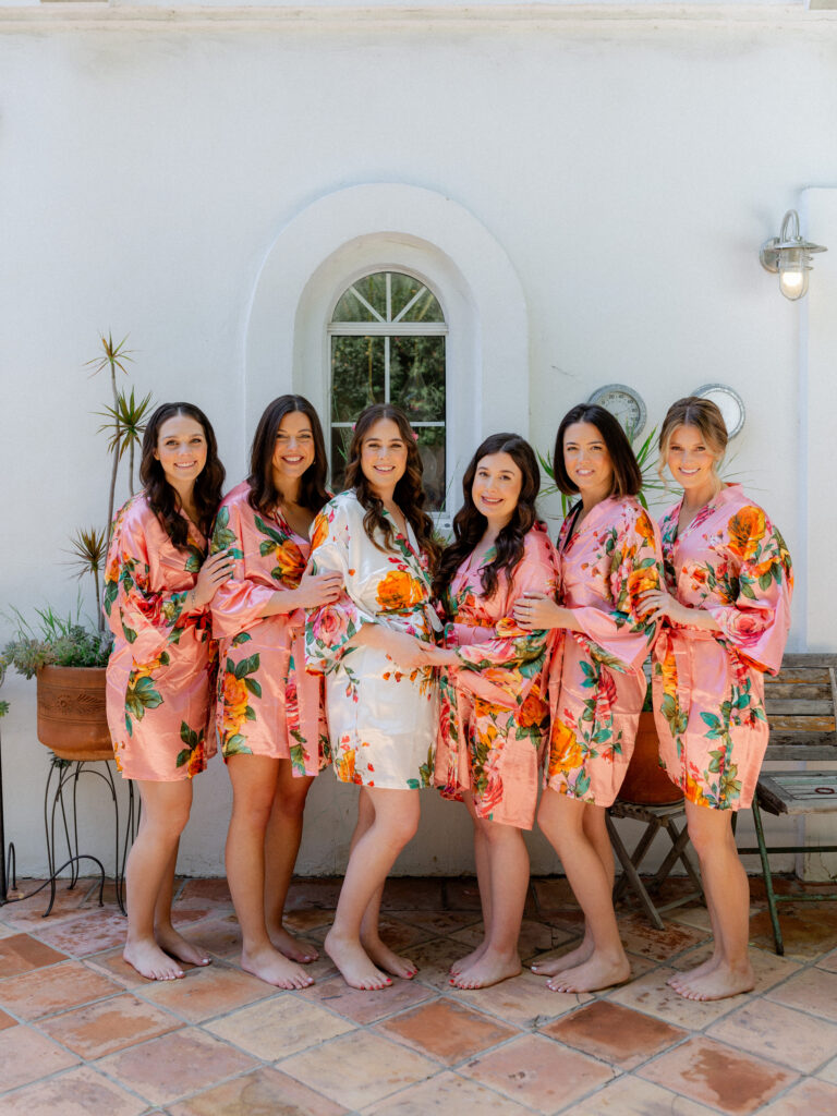 bride and bridesmaids in floral satin robes