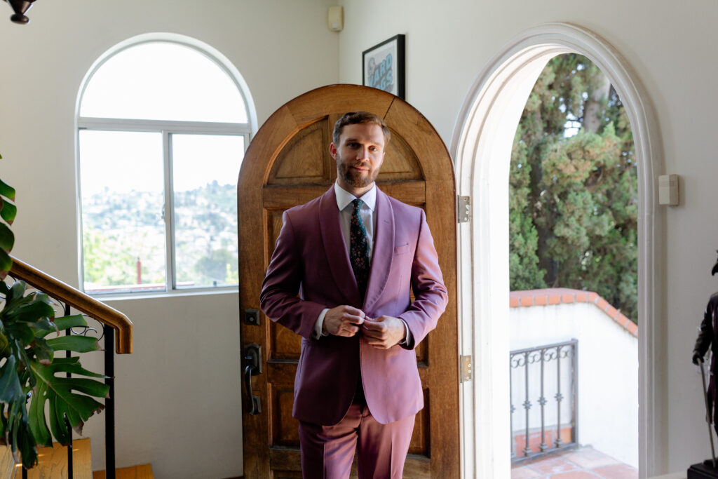 groom in merlot colored wedding suit 