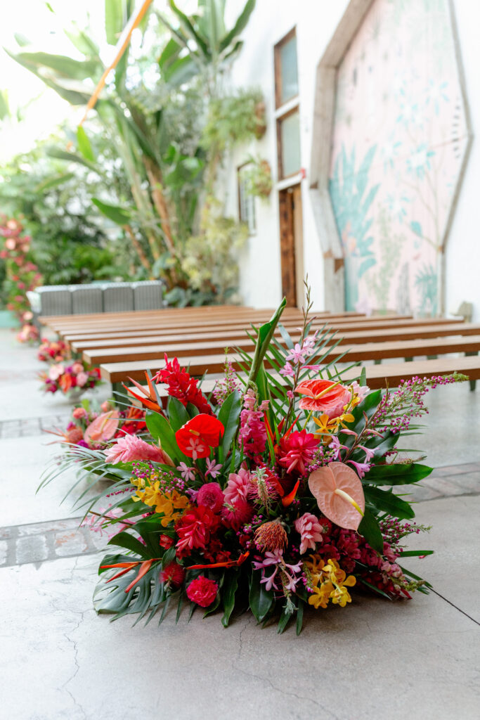 tropical inspired aisle floral arrangement