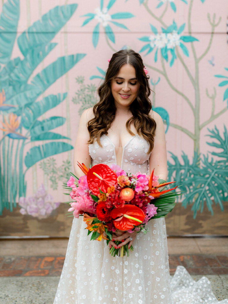 bride in strapless wedding dress with sweetheart neckline and tropical inspired wedding bouquet