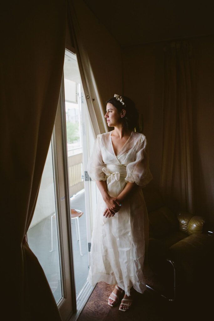 bride in modern wedding dress with sheer overlay and satin headband 