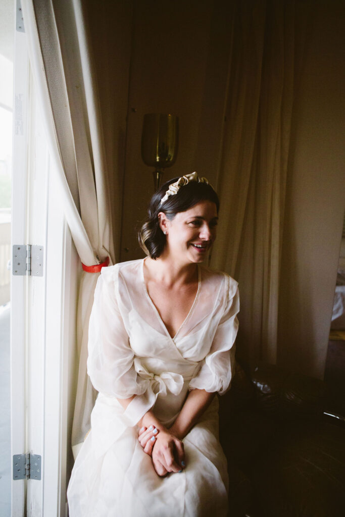 bride in modern wedding dress with sheer overlay and satin headband 