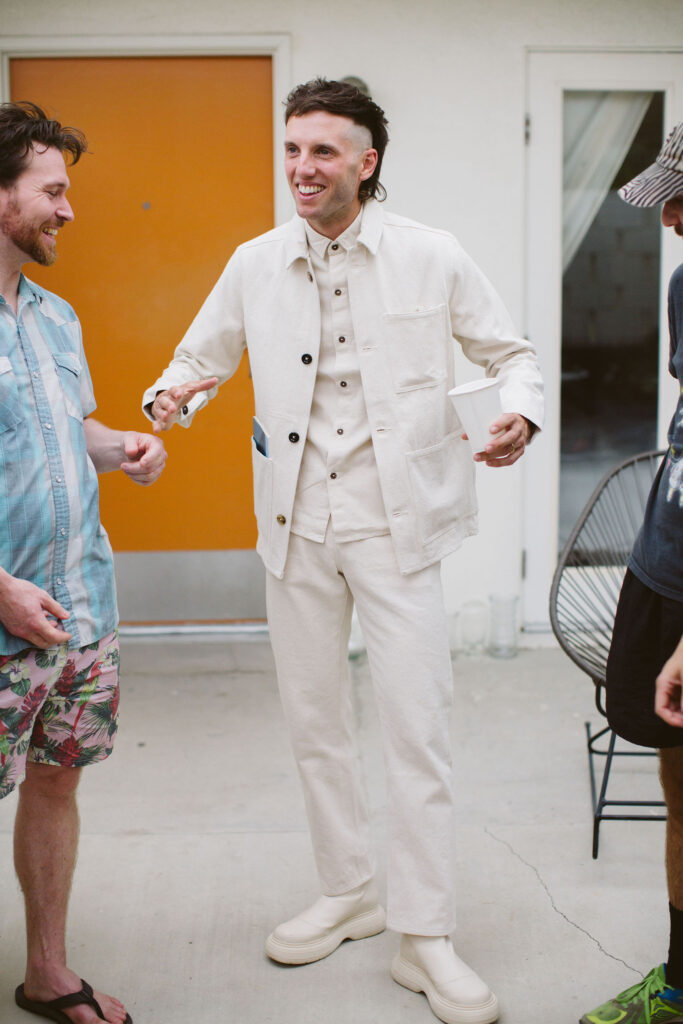 groom in all white wedding outfit