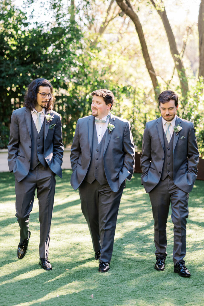 groom and groomsmen in grey blue suits with teal ties