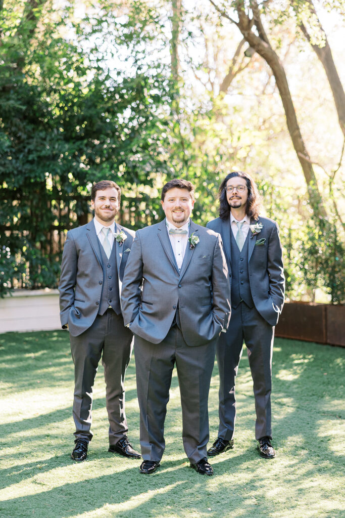 groom and groomsmen in grey blue suits with teal ties