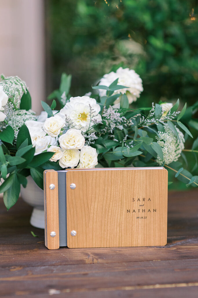 light and airy wedding welcome table with wine barrel and wooden guest book