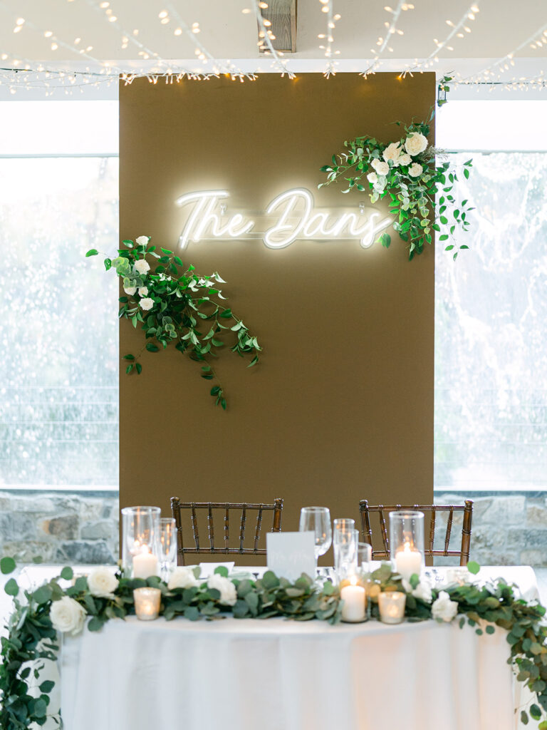 light and airy wedding reception at Calamigos Ranch with neon sign above the sweetheart table
