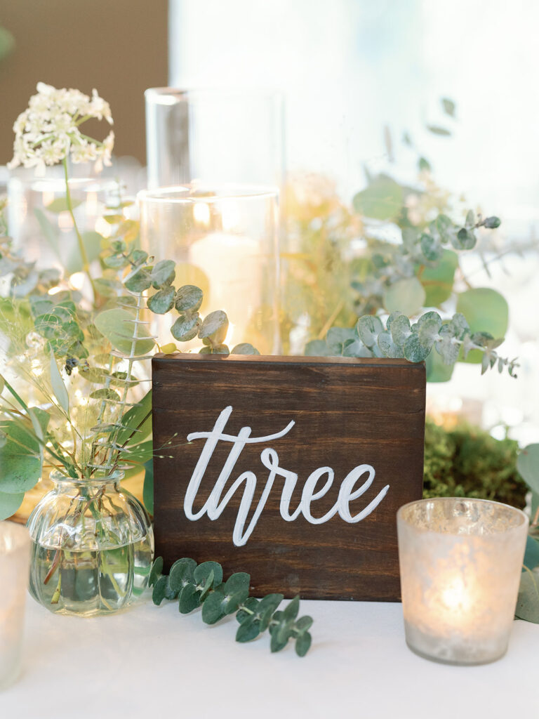 wooden table number on white linen