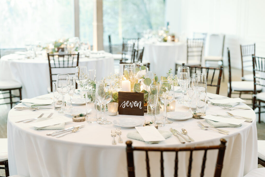 light and airy wedding reception at Calamigos Ranch with white linens and wooden table number