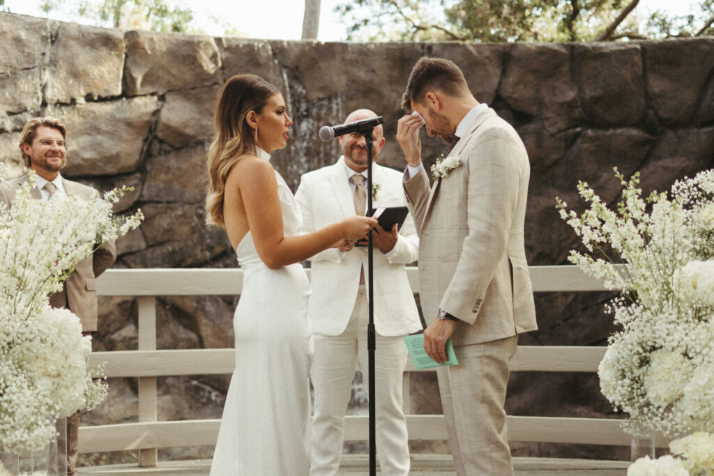 bride and emotional groom exchange vows during wedding ceremony 