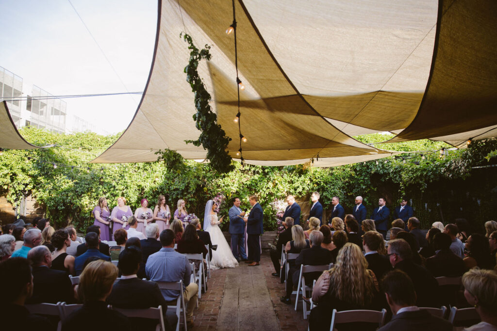 The top things to keep in mind while planning your wedding - weather like this bride and groom who used overhead canopies for shade during wedding ceremony