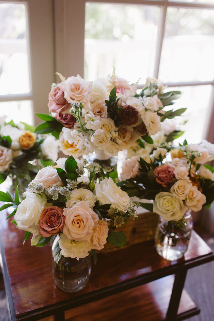 bridal and wedding party bouquets with mix of white, pink and orange flowers 