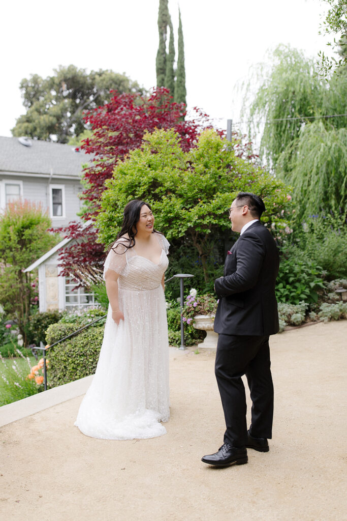 First look with groom in classic black suit with black tie and glasses and bride in beaded shutter sleeve dress | Feathered Arrow Studio, Los Angeles wedding planner